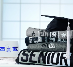  Graduation cap on a stack of t-shirt that say "Senior"